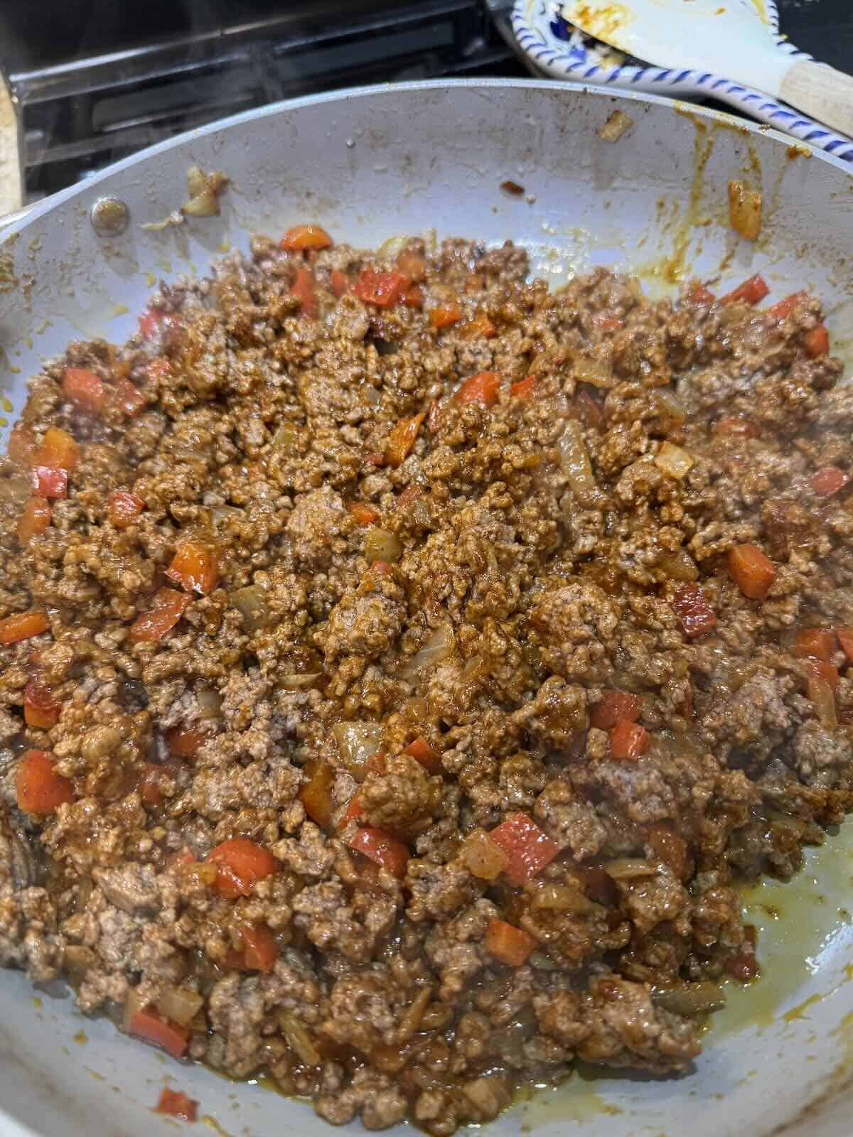taco seasoned ground beef with chopped onion and bell pepper