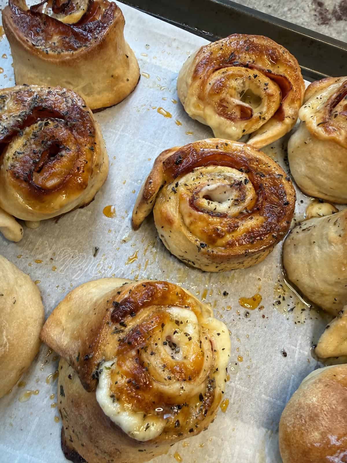 finished pepperoni pizza rolls on baking sheet