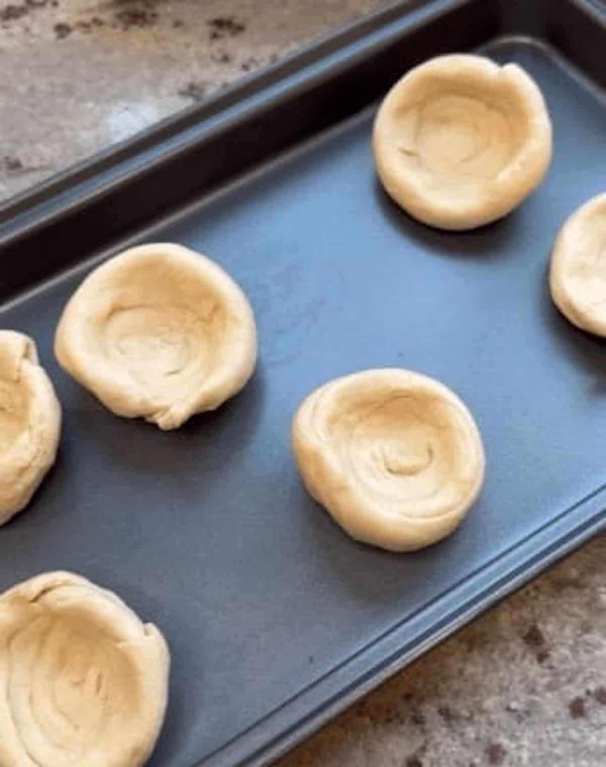pillsbury dough on baking sheet made into cups