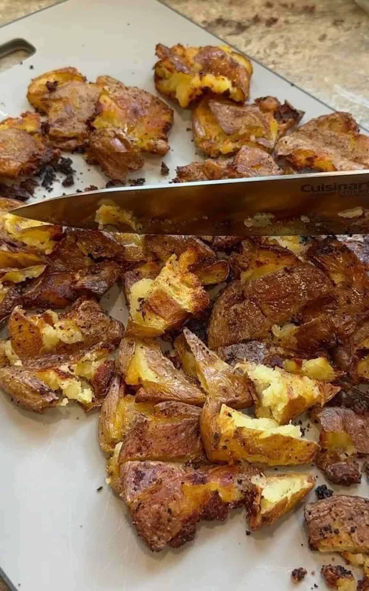 crispy smashed potatoes being rough chopped