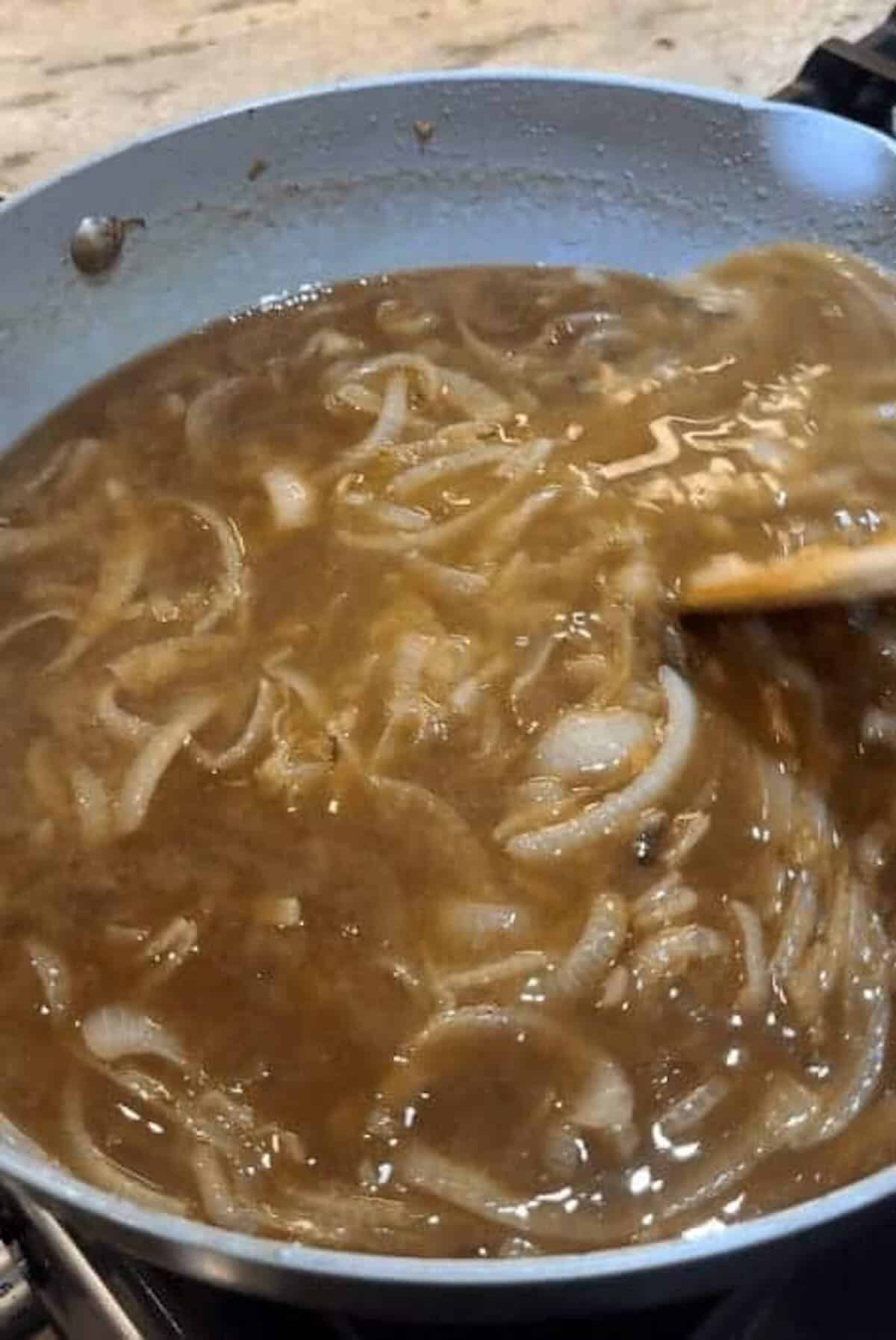 beef broth and onion in skillet