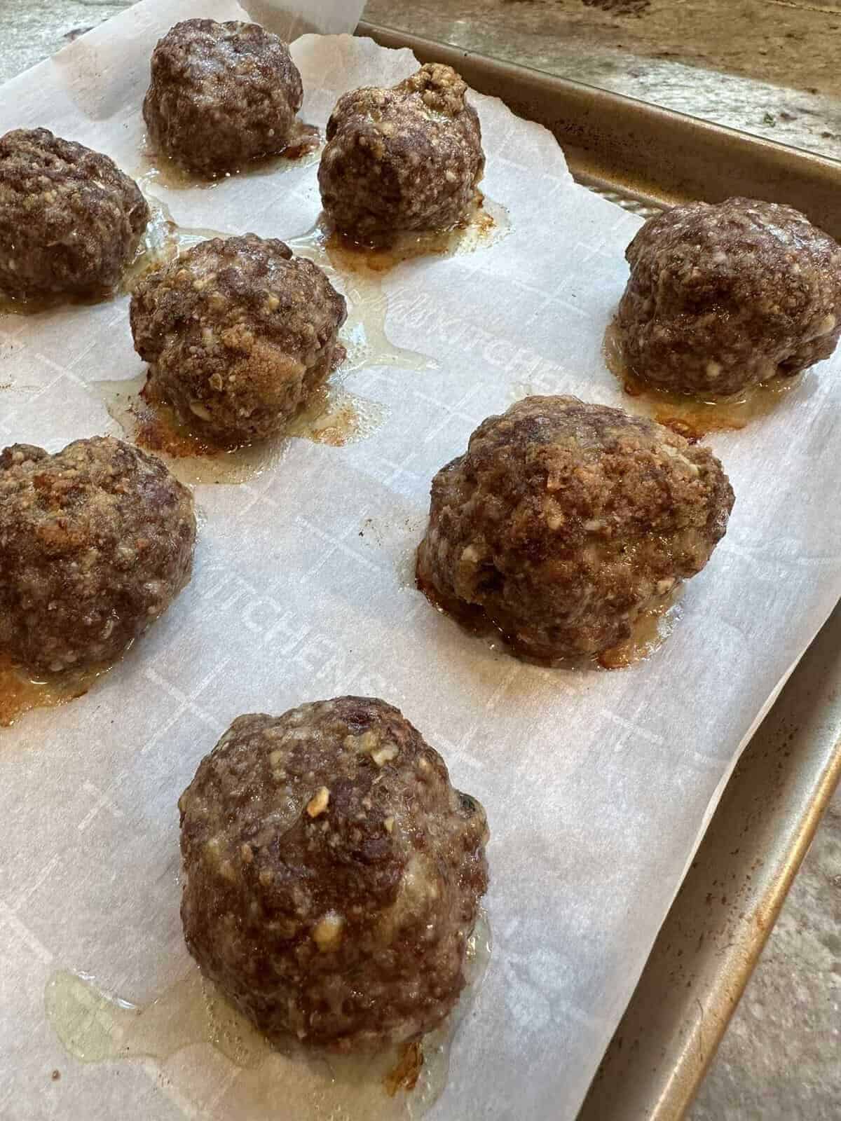 french onion meatballs on baking sheet