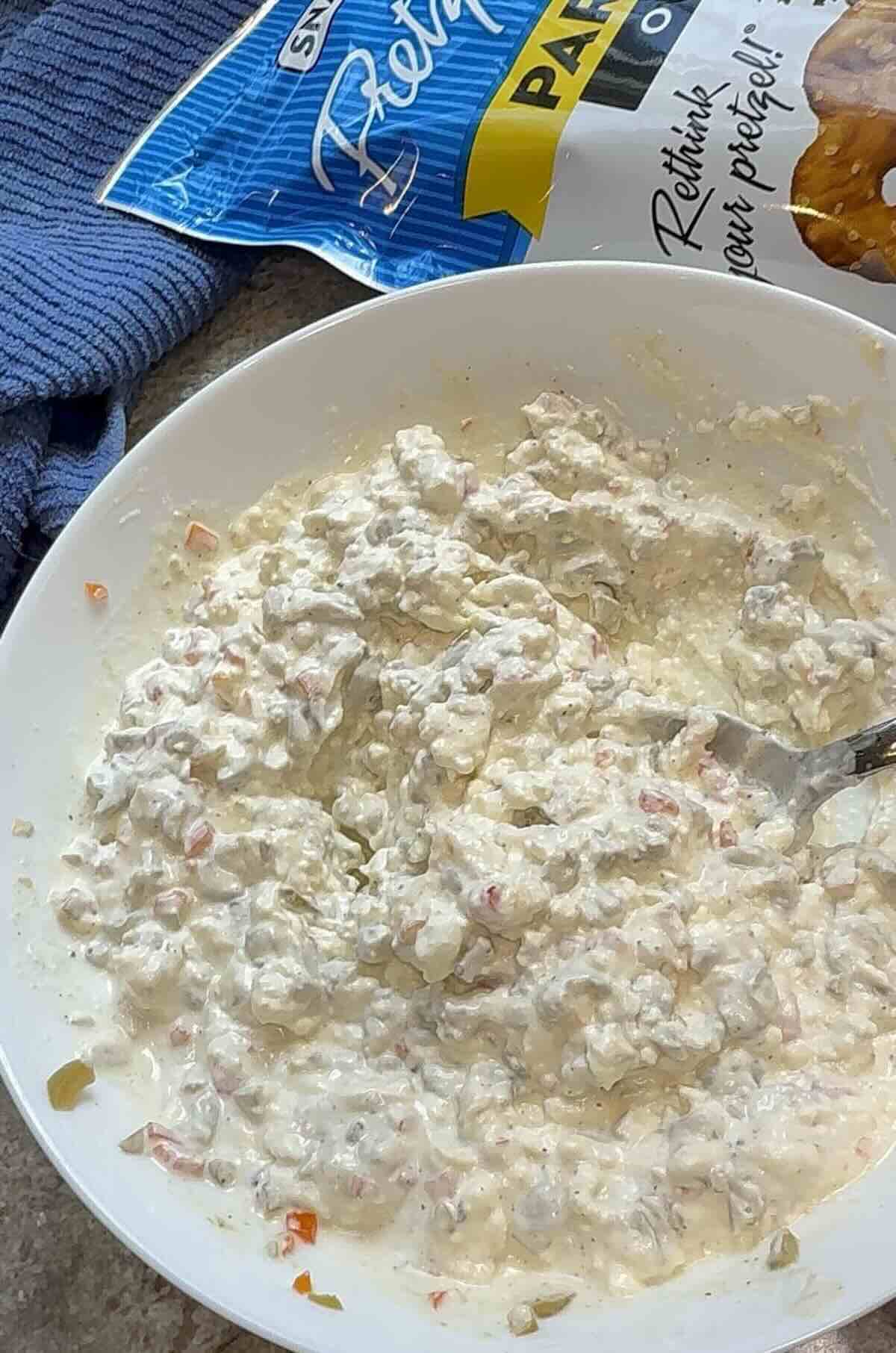 all the green olive dip ingredients mixed in a bowl