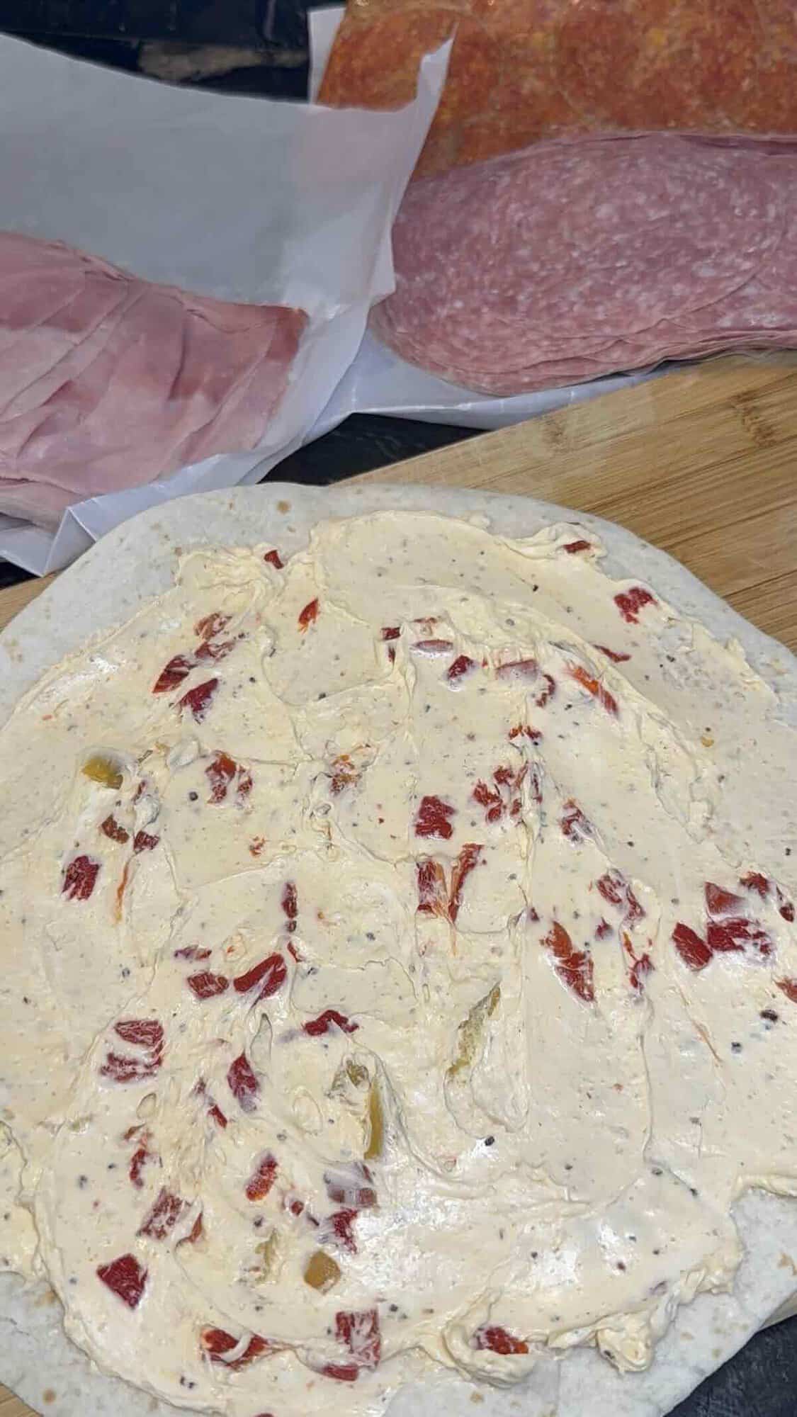 cream cheese spread onto a large tortilla