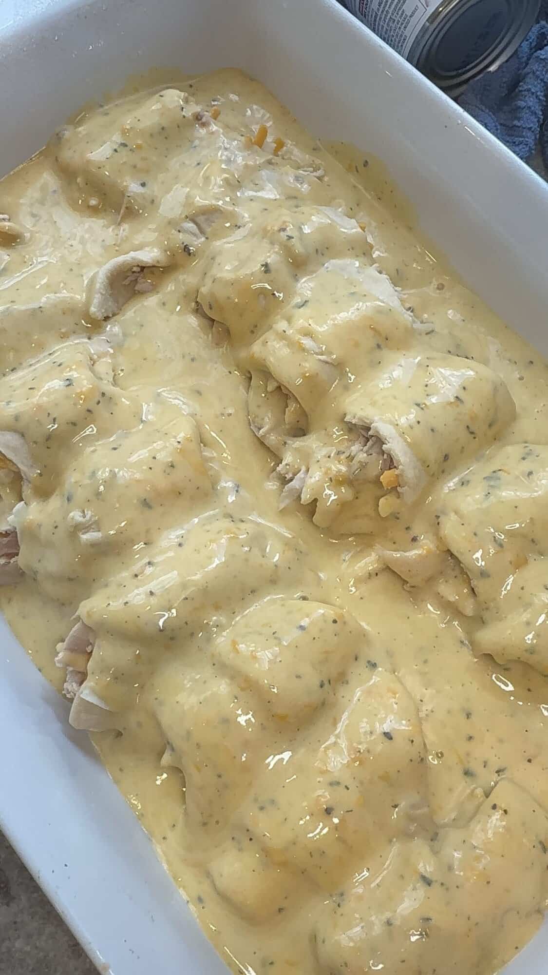 chicken and cheese stuffed crescent rolls with cheese sauce on top