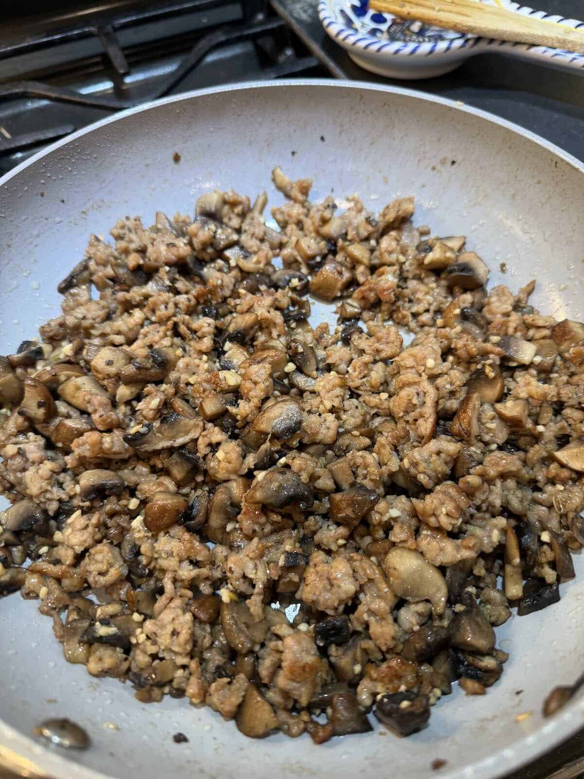 cooked sausage, sausage and garlic in a skillet