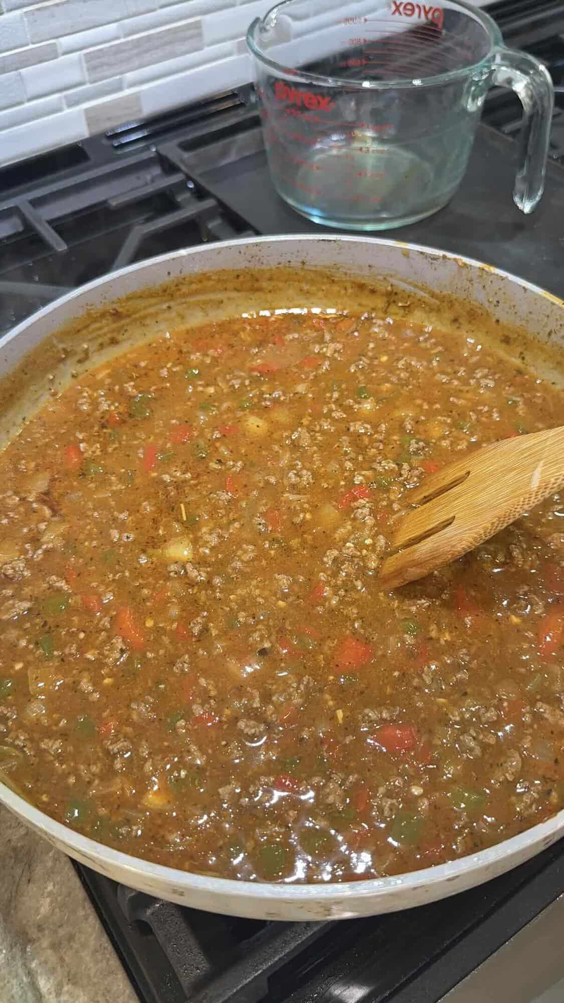 beef broth added to beef and vegetables in skillet