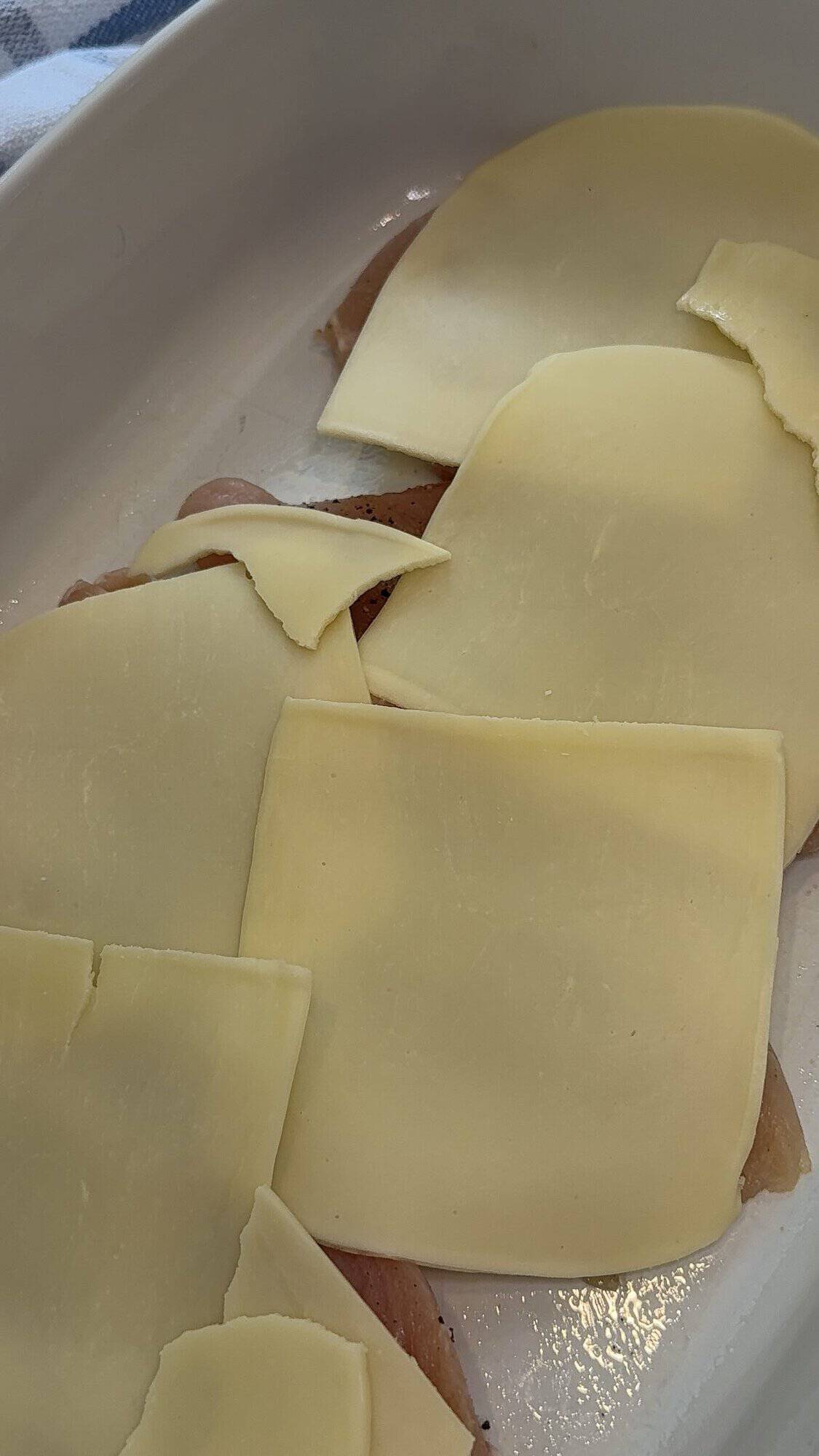 chicken breast topped with mozzarella cheese in baking dish