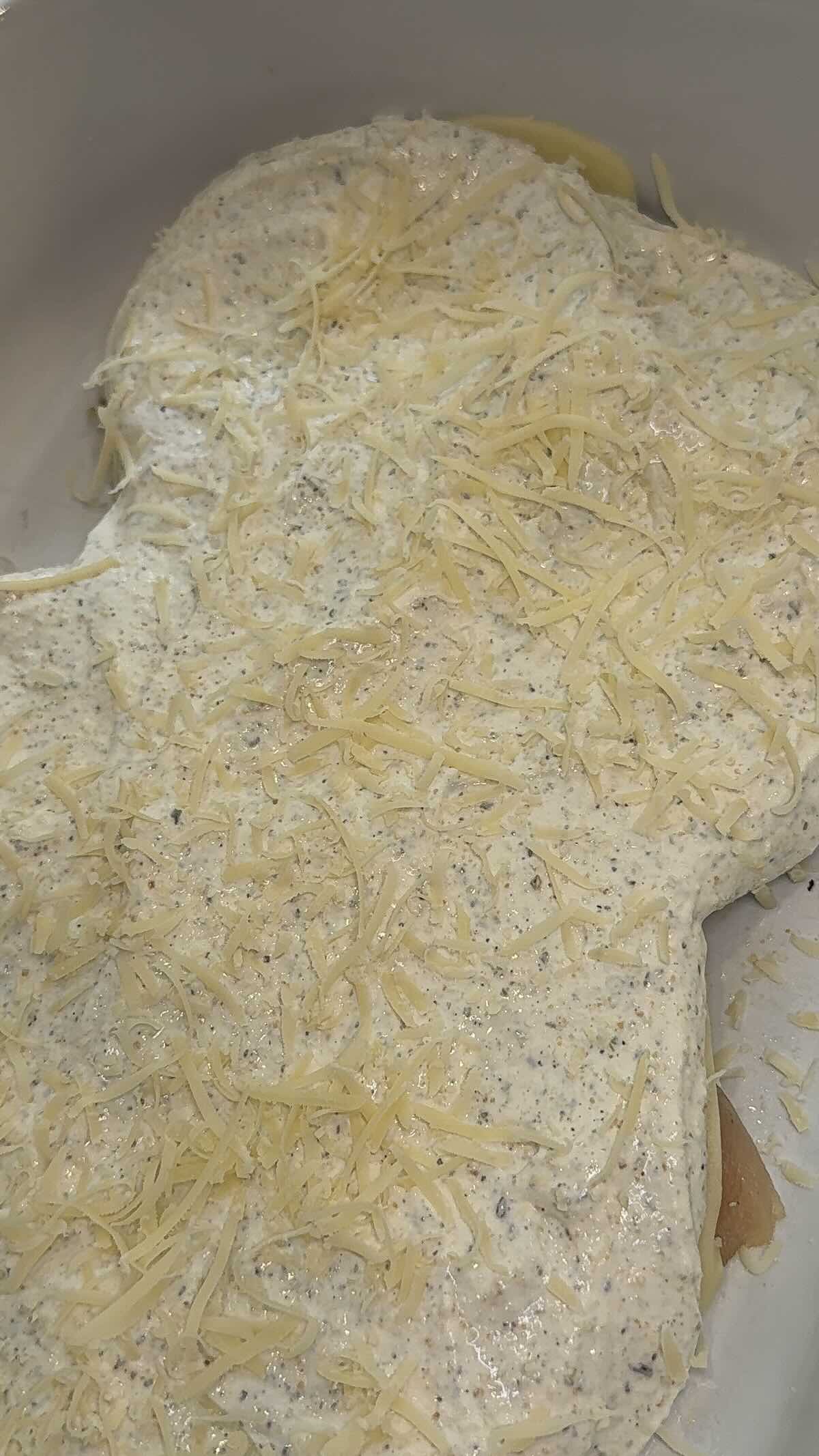 sour cream and parmesan mixture on top of chicken breast