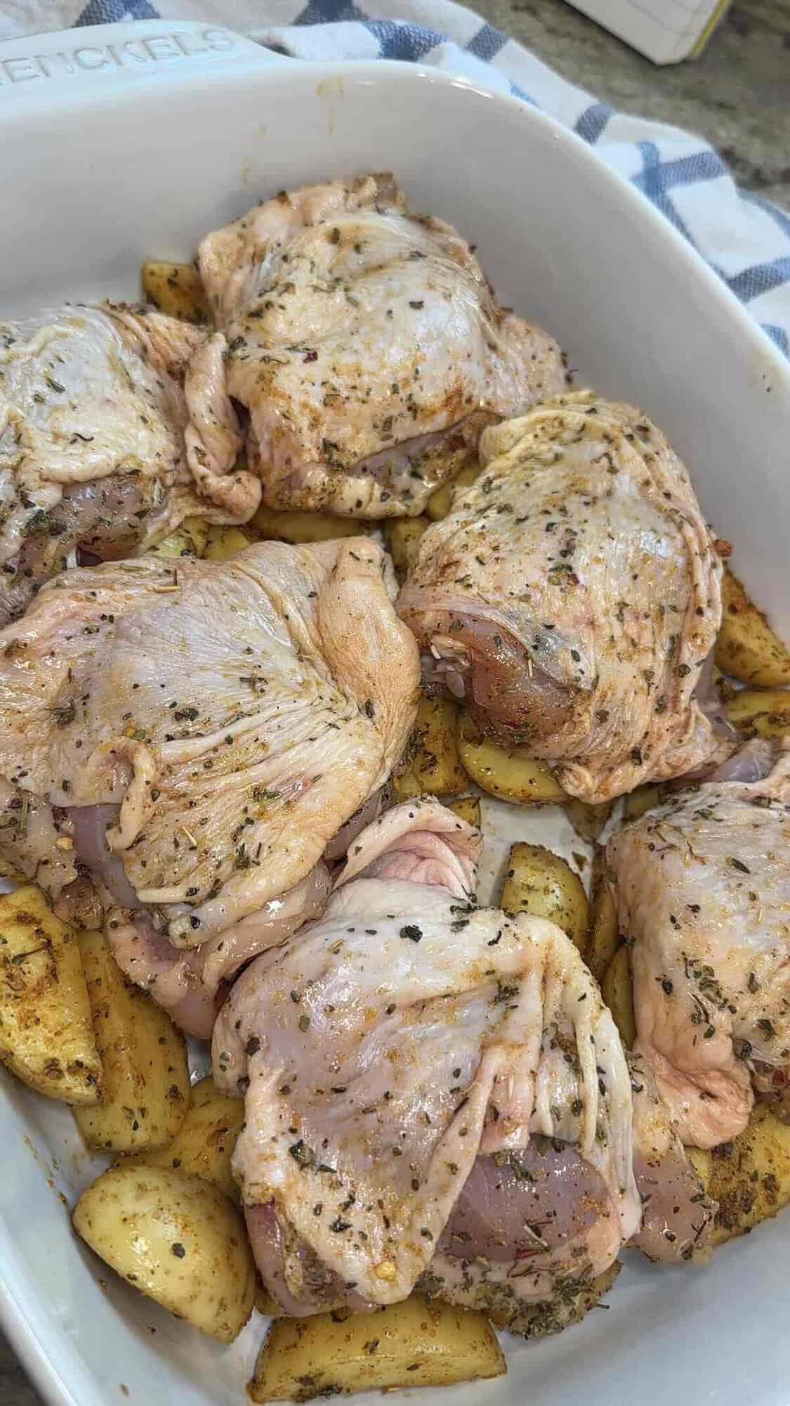 seasoned chicken thighs over potatoes