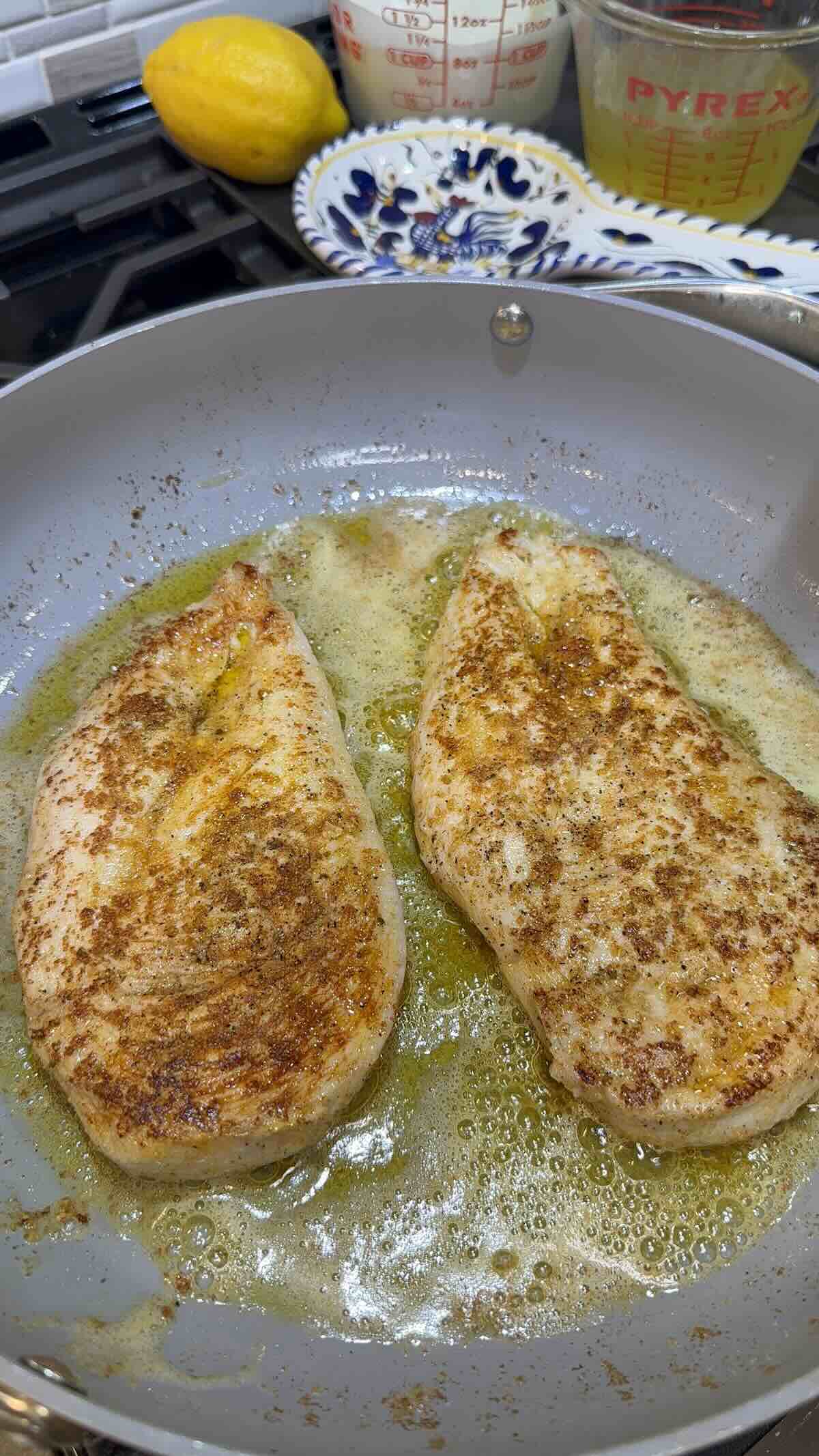 seasoned chicken browning in skillet