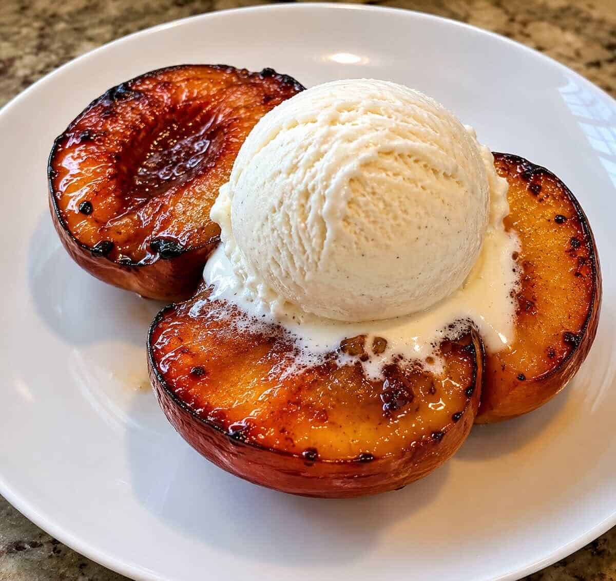 peaches topped with vanilla ice cream