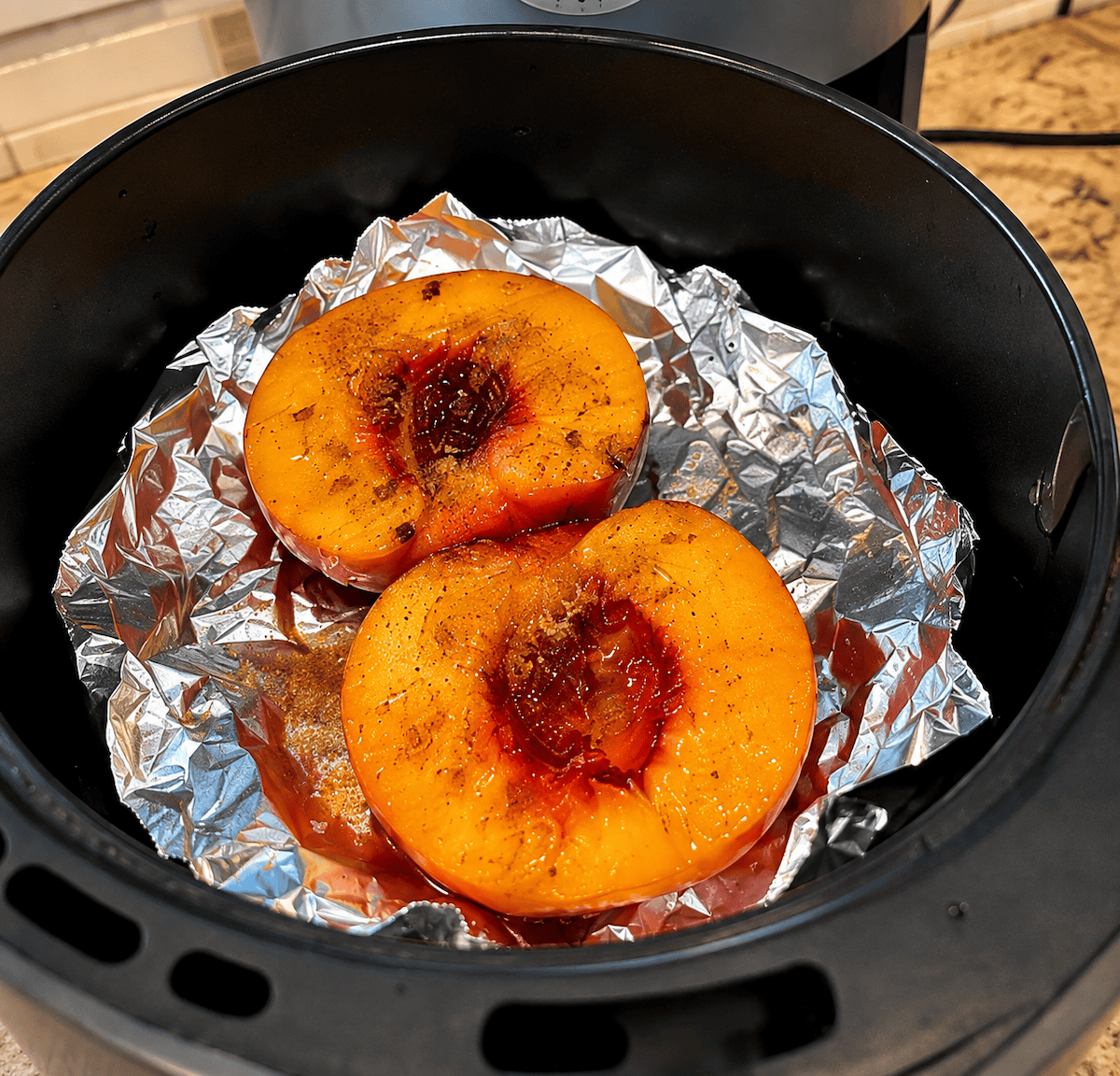 peaches covered in cinnamon, brown sugar and honey fresh out of the air fryer